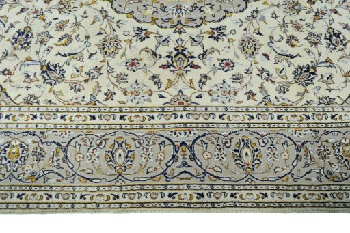 Corner detail of 2000s Kashan rug showing border pattern and Wool pile