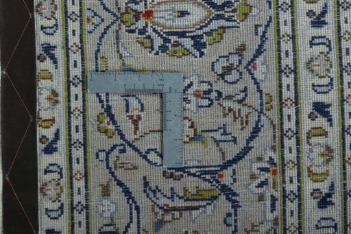 Backside of handmade 2000s Kashan rug showing knot structure and weave density