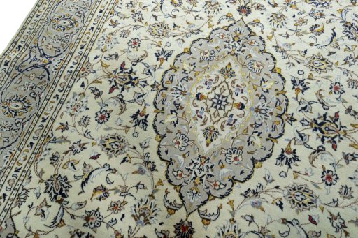 Backside of handmade 2000s Kashan rug showing knot structure and weave density