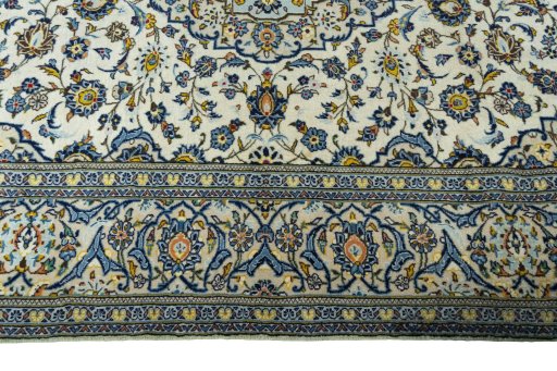 Corner detail of 2000s Kashan rug showing border pattern and Wool pile