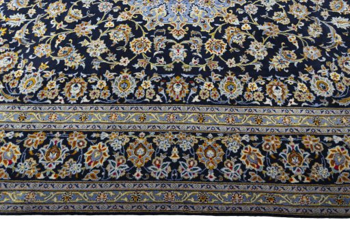 Corner detail of 2000s Kashan rug showing border pattern and Wool pile