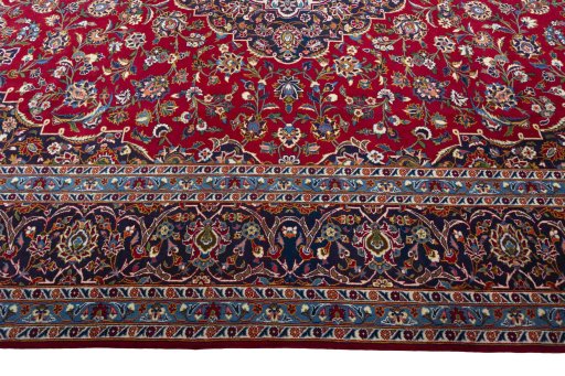 Corner detail of 2000s Kashan rug showing border pattern and Wool pile