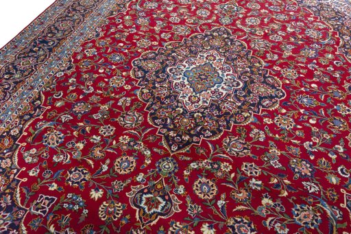 Backside of handmade 2000s Kashan rug showing knot structure and weave density