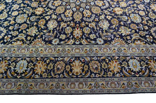 Corner detail of 2000s Kashan rug showing border pattern and Wool pile