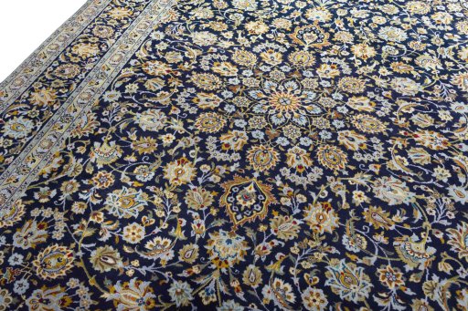 Backside of handmade 2000s Kashan rug showing knot structure and weave density