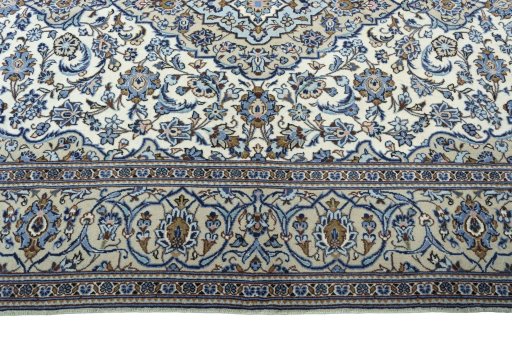 Corner detail of 2000s Kashan rug showing border pattern and Wool pile