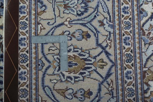 Backside of handmade 2000s Kashan rug showing knot structure and weave density