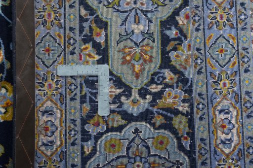Backside of handmade 2000s Kashan rug showing knot structure and weave density