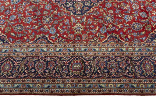 Corner detail of 2000s Kashan rug showing border pattern and Cork pile
