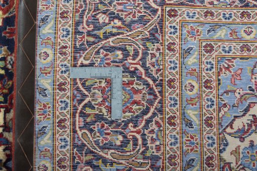 Backside of handmade 2000s Kashan rug showing knot structure and weave density
