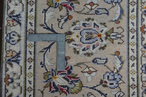 Backside of handmade 2000s Kashan rug showing knot structure and weave density
