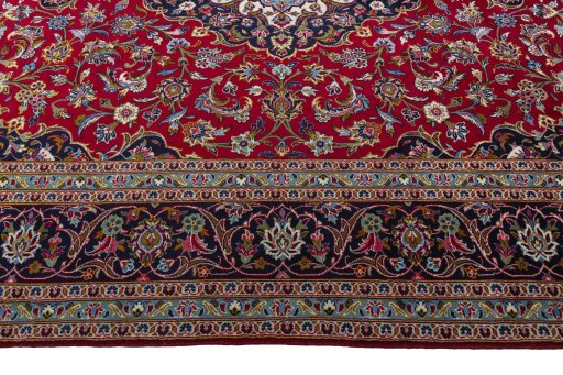 Corner detail of 2000s Kashan rug showing border pattern and Wool pile
