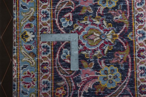 Backside of handmade 2000s Kashan rug showing knot structure and weave density