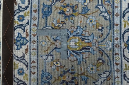 Backside of handmade 2000s Kashan rug showing knot structure and weave density