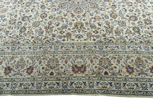 Corner detail of 2000s Kashan rug showing border pattern and Cork pile