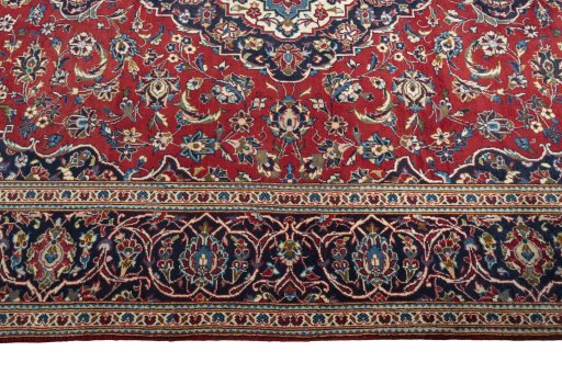Corner detail of 2000s Kashan rug showing border pattern and Wool pile