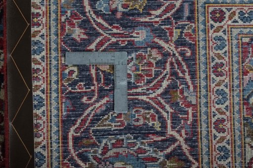 Backside of handmade 2000s Kashan rug showing knot structure and weave density