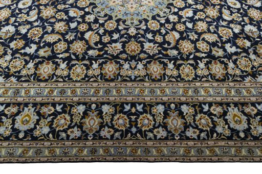 Corner detail of 2000s Kashan rug showing border pattern and Wool pile