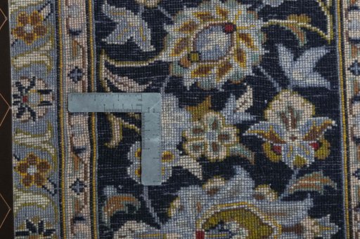 Backside of handmade 2000s Kashan rug showing knot structure and weave density