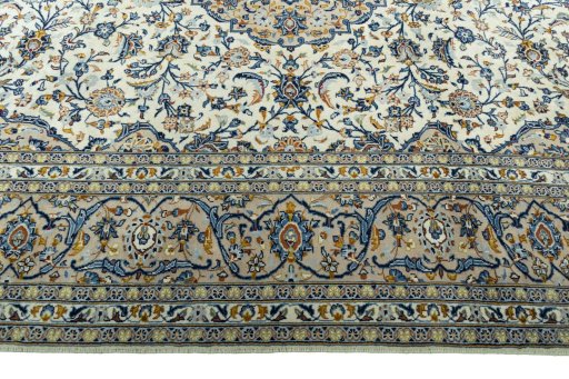 Corner detail of 2000s Kashan rug showing border pattern and Wool pile