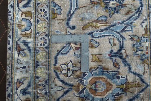 Backside of handmade 2000s Kashan rug showing knot structure and weave density
