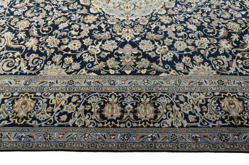 Corner detail of 2000s Kashan rug showing border pattern and Wool pile