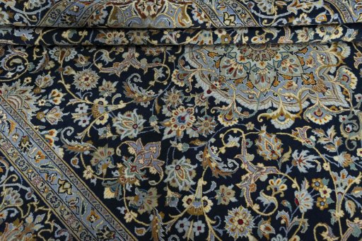 Close-up detail of 2000s Kashan rug from Iran / Persia showing Wool weave