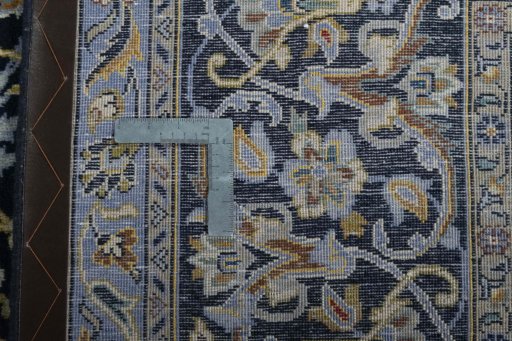 Backside of handmade 2000s Kashan rug showing knot structure and weave density