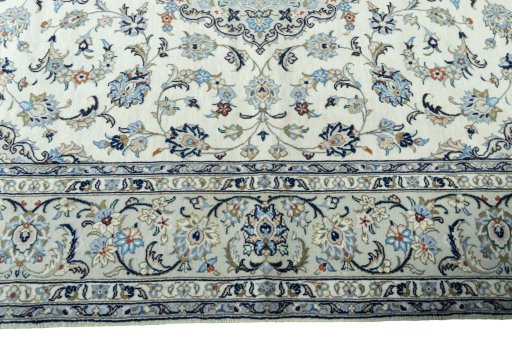 Corner detail of 2000s Kashan rug showing border pattern and Wool pile
