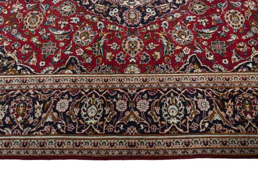Corner detail of 2000s Kashan rug showing border pattern and Wool pile