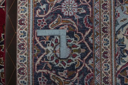 Backside of handmade 2000s Kashan rug showing knot structure and weave density