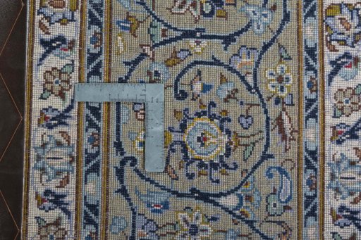 Backside of handmade 2000s Kashan rug showing knot structure and weave density
