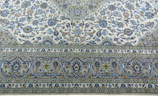 Corner detail of 2000s Kashan rug showing border pattern and Cork pile
