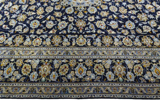 Corner detail of 2000s Kashan rug showing border pattern and Wool pile