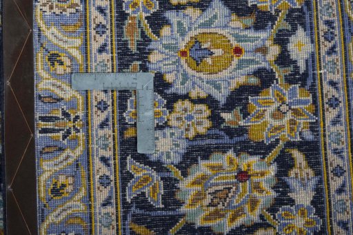 Backside of handmade 2000s Kashan rug showing knot structure and weave density