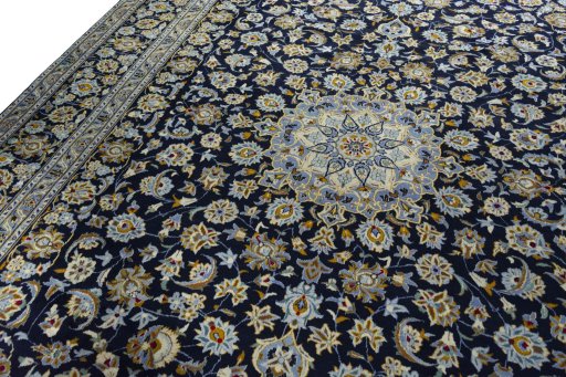 Backside of handmade 2000s Kashan rug showing knot structure and weave density