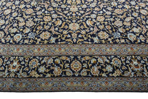 Corner detail of 2000s Kashan rug showing border pattern and Wool pile