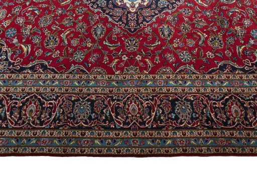 Corner detail of 2000s Kashan rug showing border pattern and Wool pile