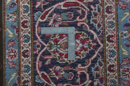 Backside of handmade 2000s Kashan rug showing knot structure and weave density