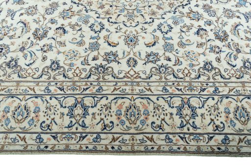 Corner detail of 2000s Kashan rug showing border pattern and Wool pile