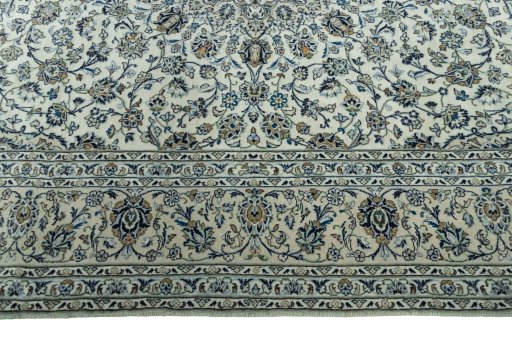 Corner detail of 2000s Kashan rug showing border pattern and Wool pile