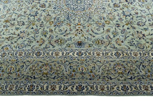 Corner detail of 2000s Kashan rug showing border pattern and Wool pile