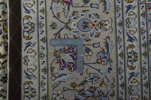 Backside of handmade 2000s Kashan rug showing knot structure and weave density