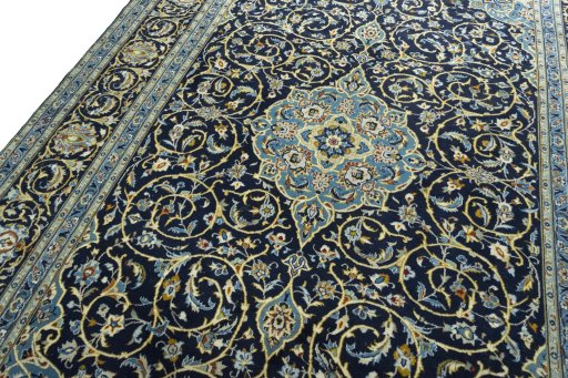 Backside of handmade 2000s Kashan rug showing knot structure and weave density