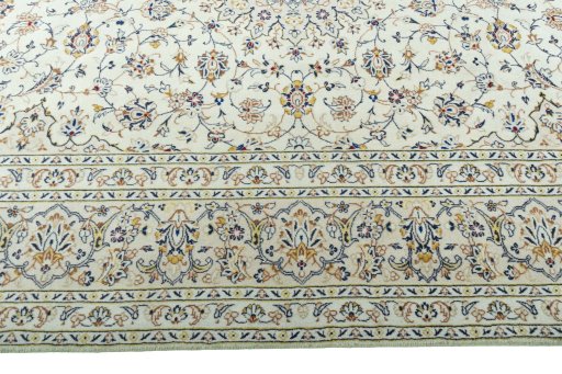 Corner detail of 2000s Kashan rug showing border pattern and Wool pile