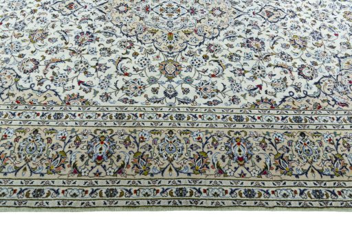 Corner detail of 2000s Kashan rug showing border pattern and Wool pile