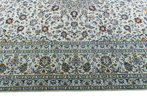 Corner detail of 2000s Kashan rug showing border pattern and Wool pile