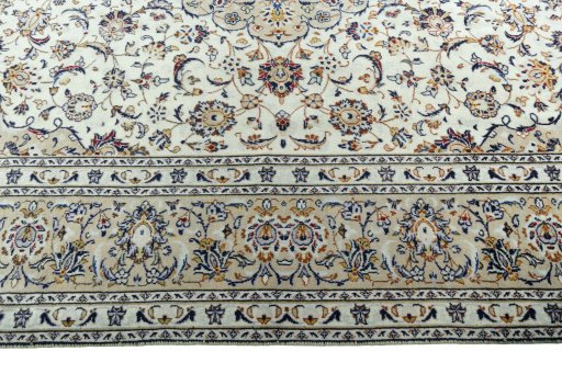 Corner detail of 2000s Kashan rug showing border pattern and Wool pile
