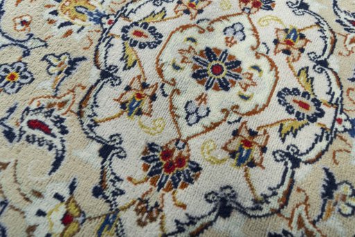 Backside of handmade 2000s Kashan rug showing knot structure and weave density