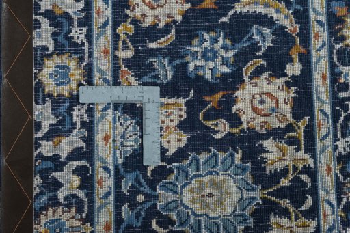 Backside of handmade 2000s Kashan rug showing knot structure and weave density